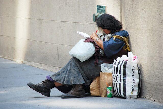 homeleess woman sitting on street